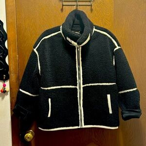 Elan faux leather accents, with nickel detail on neck